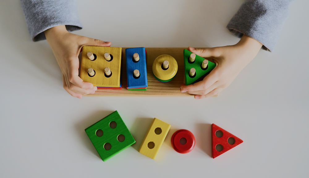 young child playing with colorful building blocks